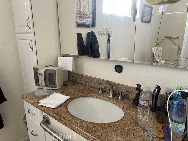 bathroom featuring vanity and walk in shower