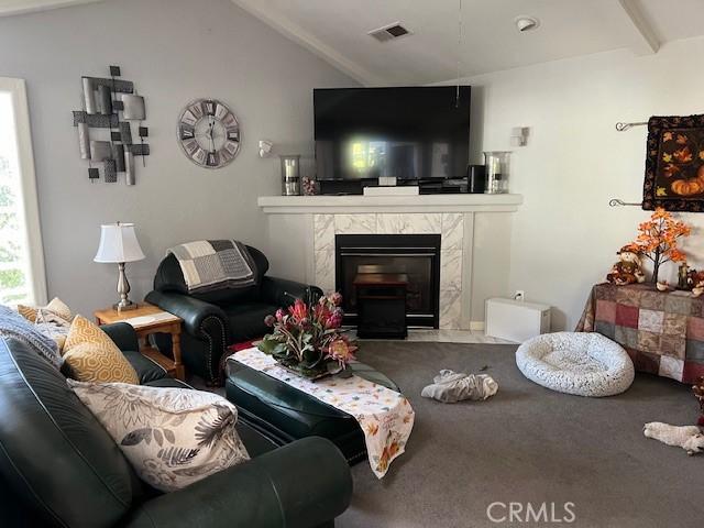 living room with lofted ceiling and a premium fireplace