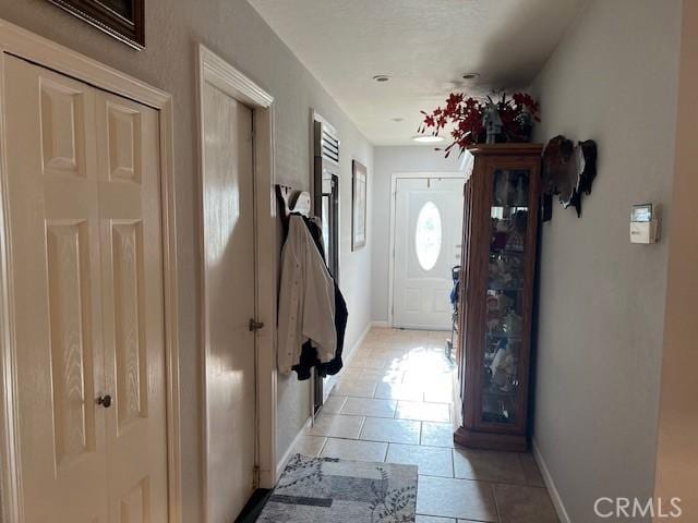 doorway with light tile patterned floors