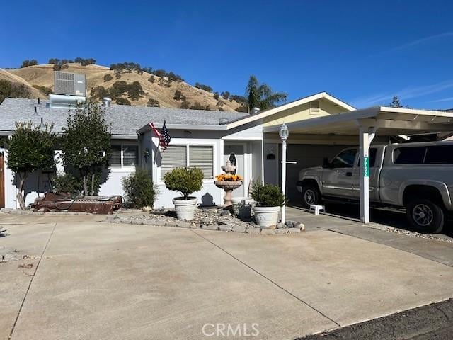 view of front of property featuring a mountain view and a carport