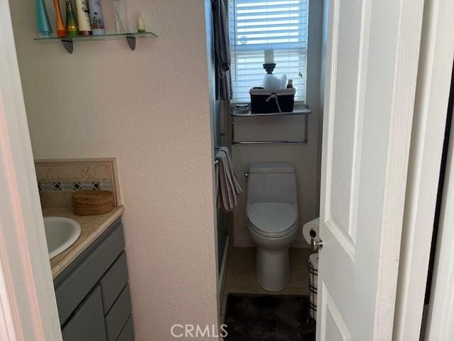 bathroom featuring vanity and toilet