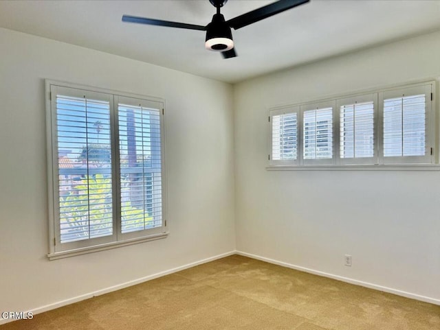 carpeted spare room with ceiling fan