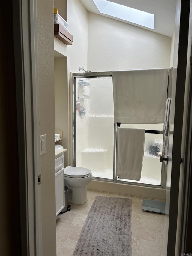 bathroom with tile patterned flooring, vanity, toilet, and an enclosed shower