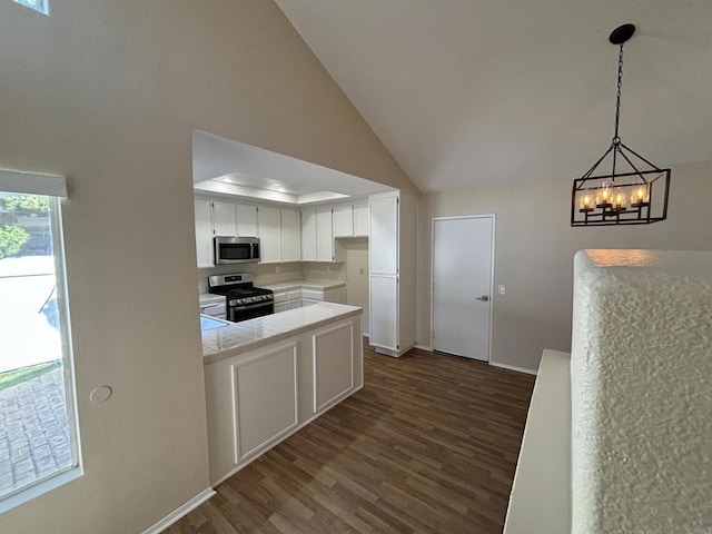 kitchen with stainless steel appliances, dark hardwood / wood-style floors, a chandelier, pendant lighting, and white cabinets