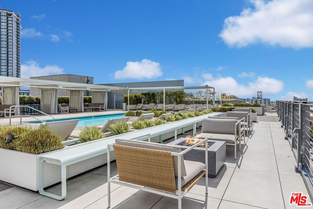 view of pool featuring a fire pit and a patio area