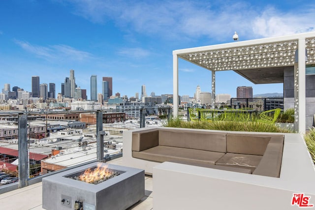 view of patio / terrace featuring an outdoor living space with a fire pit