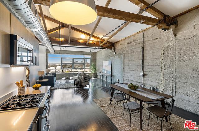 dining room with beamed ceiling, hardwood / wood-style floors, and high vaulted ceiling