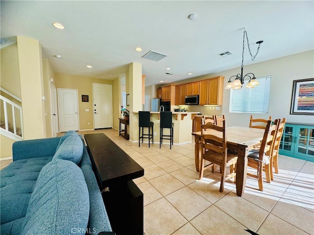 dining room featuring light tile patterned floors and a chandelier