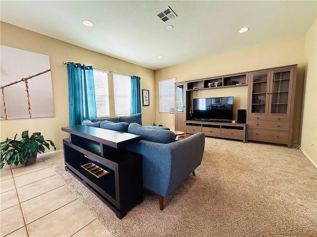 living room with light tile patterned floors and a textured ceiling