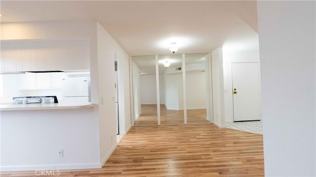 corridor featuring light wood-type flooring