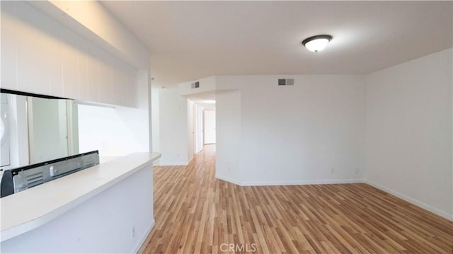 empty room with light hardwood / wood-style flooring