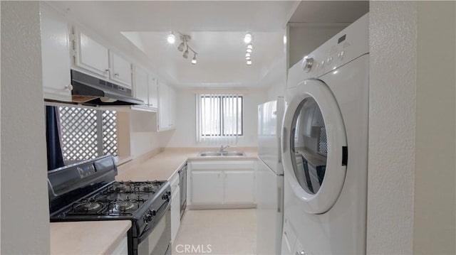 kitchen featuring black range with gas stovetop, washer / clothes dryer, sink, and white cabinets