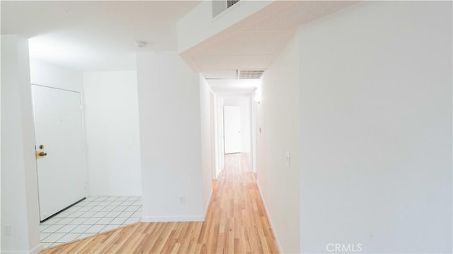 corridor with light wood-type flooring