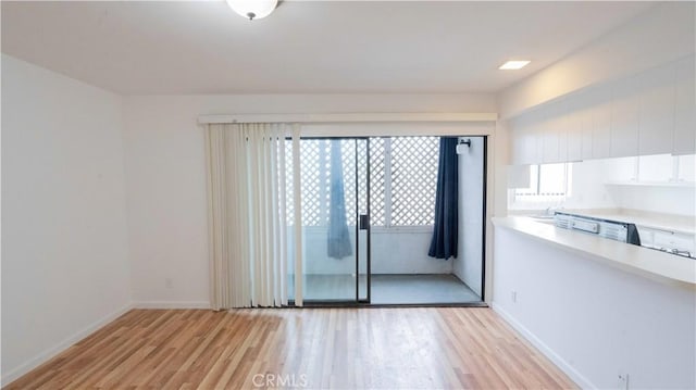 spare room featuring light hardwood / wood-style floors