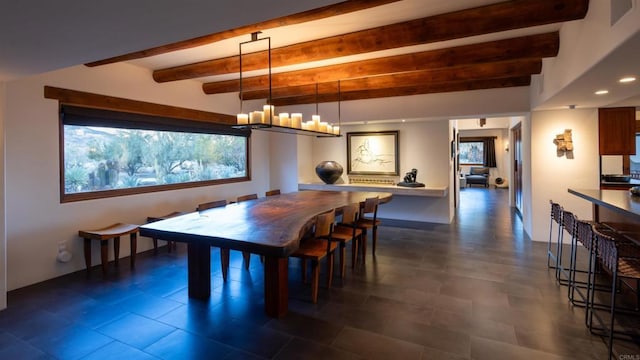 dining space featuring a chandelier and beamed ceiling