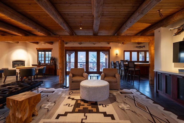 living room featuring french doors, beamed ceiling, and plenty of natural light