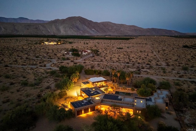 aerial view at dusk featuring a mountain view