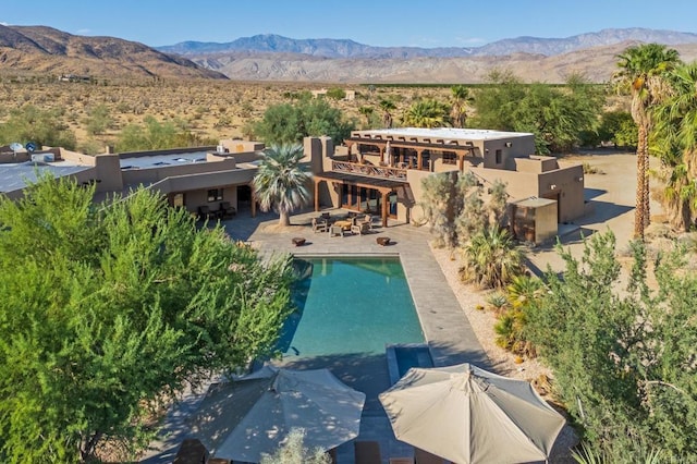 exterior space with a mountain view and a patio area