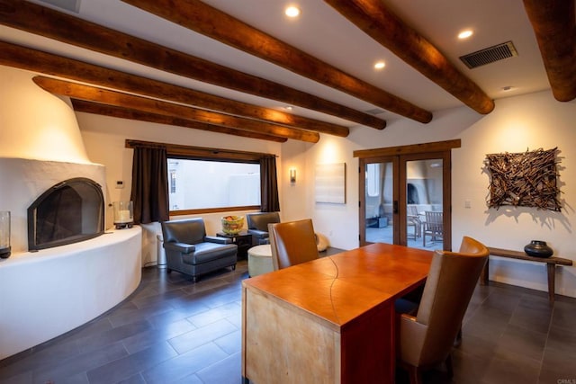 dining area featuring french doors, beam ceiling, and a large fireplace