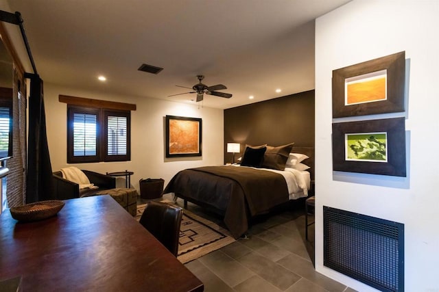 tiled bedroom featuring ceiling fan