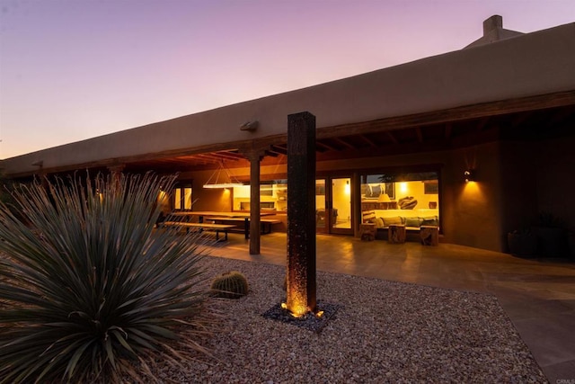 view of patio terrace at dusk