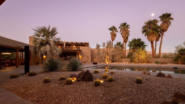 yard at dusk featuring a patio area