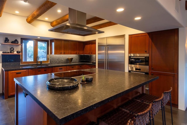 kitchen with a spacious island, stainless steel built in fridge, beamed ceiling, sink, and island range hood