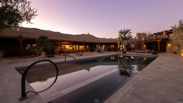 view of pool at dusk