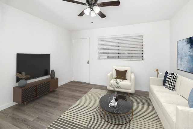 living room featuring hardwood / wood-style floors and ceiling fan