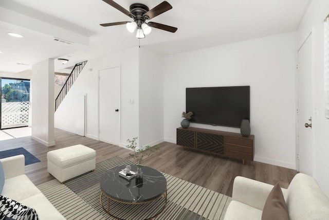 living room featuring wood-type flooring and ceiling fan