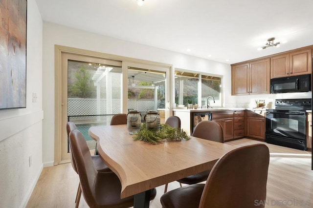 dining area featuring light hardwood / wood-style flooring and sink