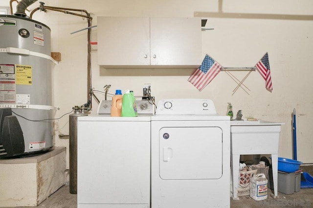 laundry area featuring secured water heater, washer and dryer, and cabinets