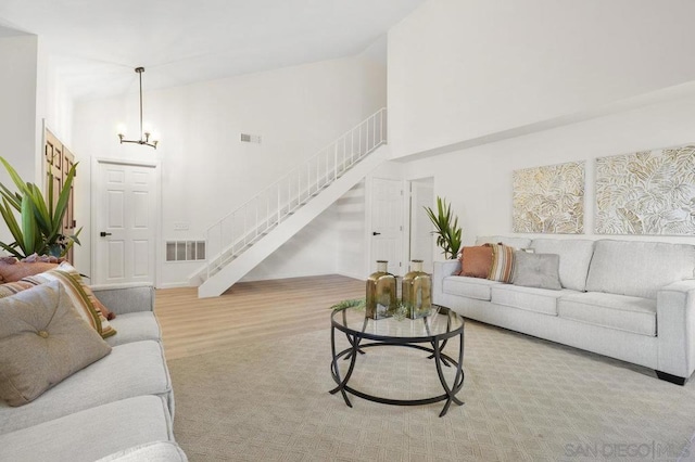 living room with a high ceiling and light hardwood / wood-style flooring