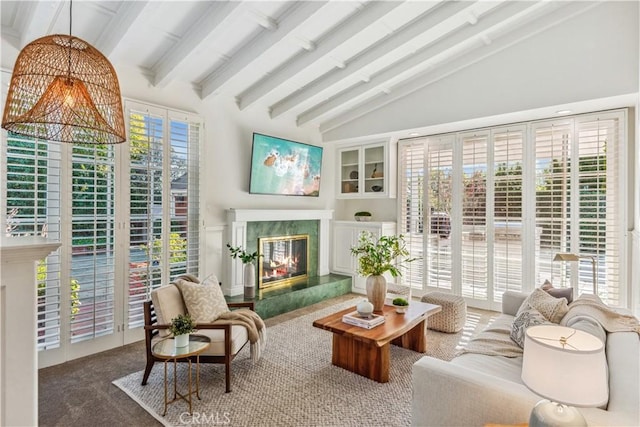 sunroom with a high end fireplace and lofted ceiling with beams