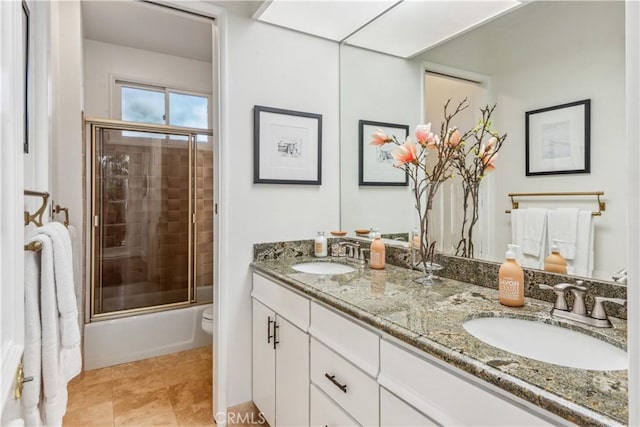 full bathroom with vanity, toilet, and enclosed tub / shower combo