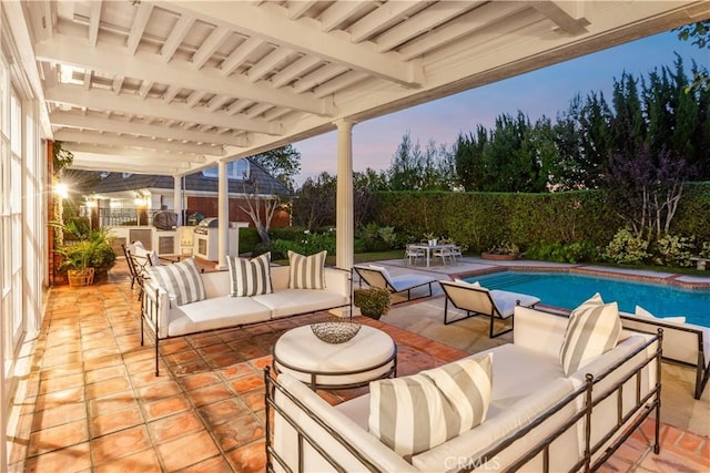 patio terrace at dusk with an outdoor living space and a fenced in pool