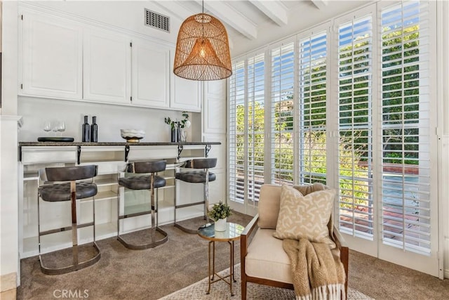 sunroom featuring beamed ceiling