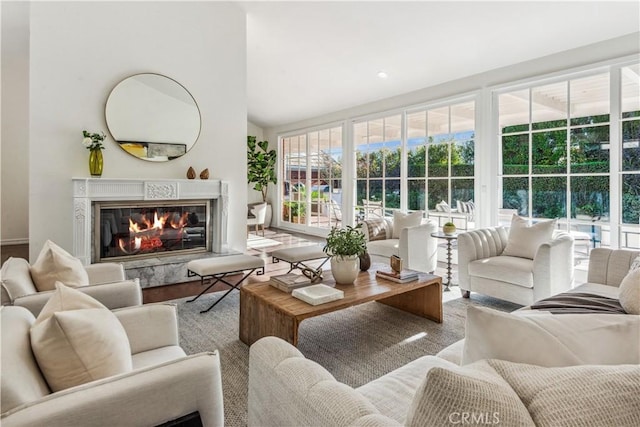 sunroom featuring a high end fireplace