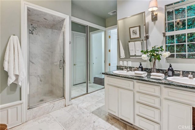 bathroom with vanity and a shower with shower door