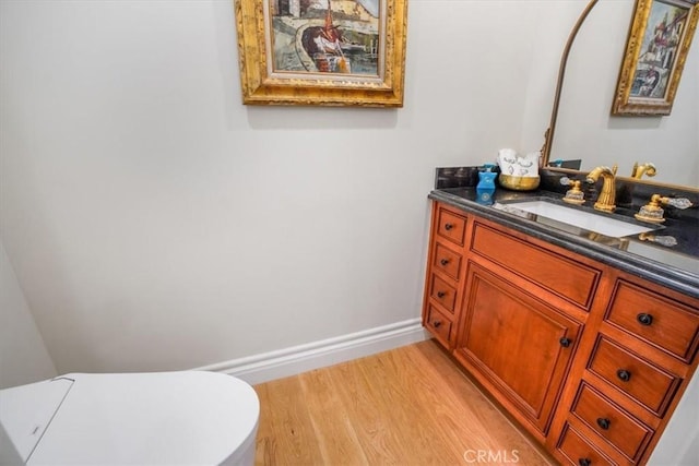 bathroom featuring hardwood / wood-style floors, vanity, and toilet