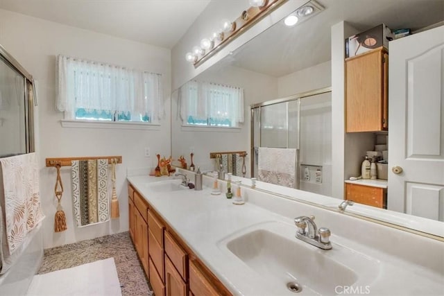 bathroom featuring vanity and a shower with door