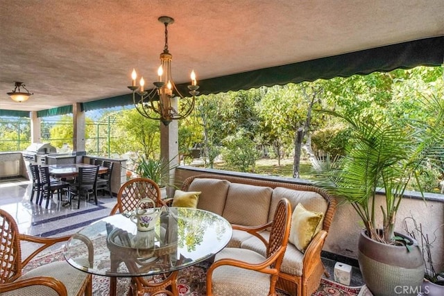 sunroom / solarium featuring an inviting chandelier