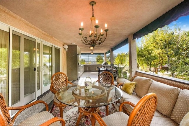 sunroom featuring a notable chandelier