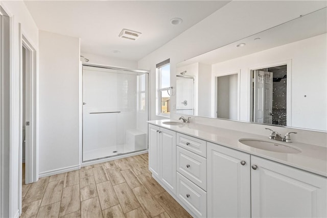 bathroom featuring an enclosed shower and vanity