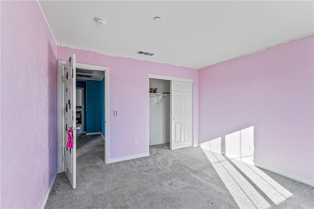 unfurnished bedroom featuring light colored carpet and a closet