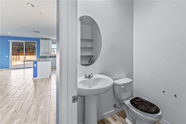 bathroom featuring toilet and built in shelves