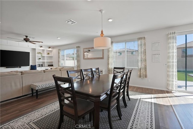 dining space featuring a wealth of natural light, dark wood-type flooring, and ceiling fan