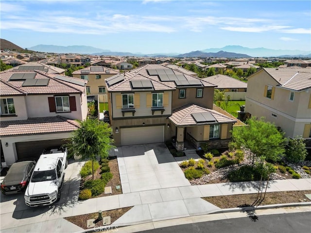 view of front facade with a mountain view and a garage