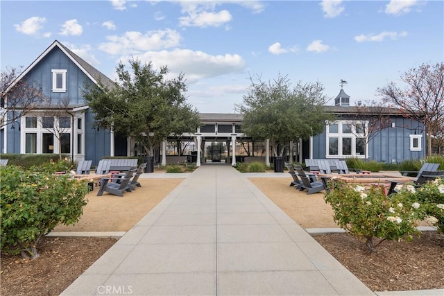 view of home's community featuring an outdoor fire pit