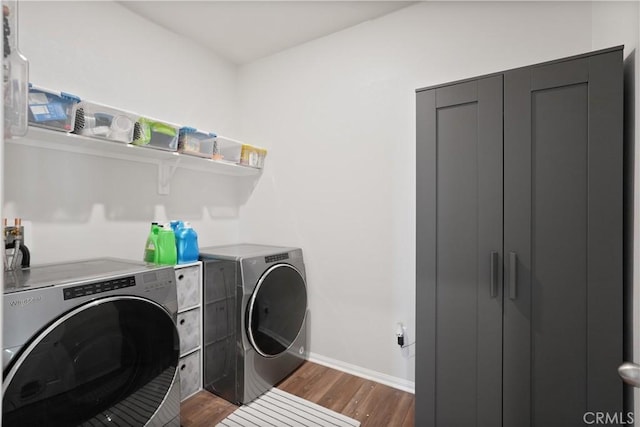 laundry room featuring washer and clothes dryer and dark hardwood / wood-style floors